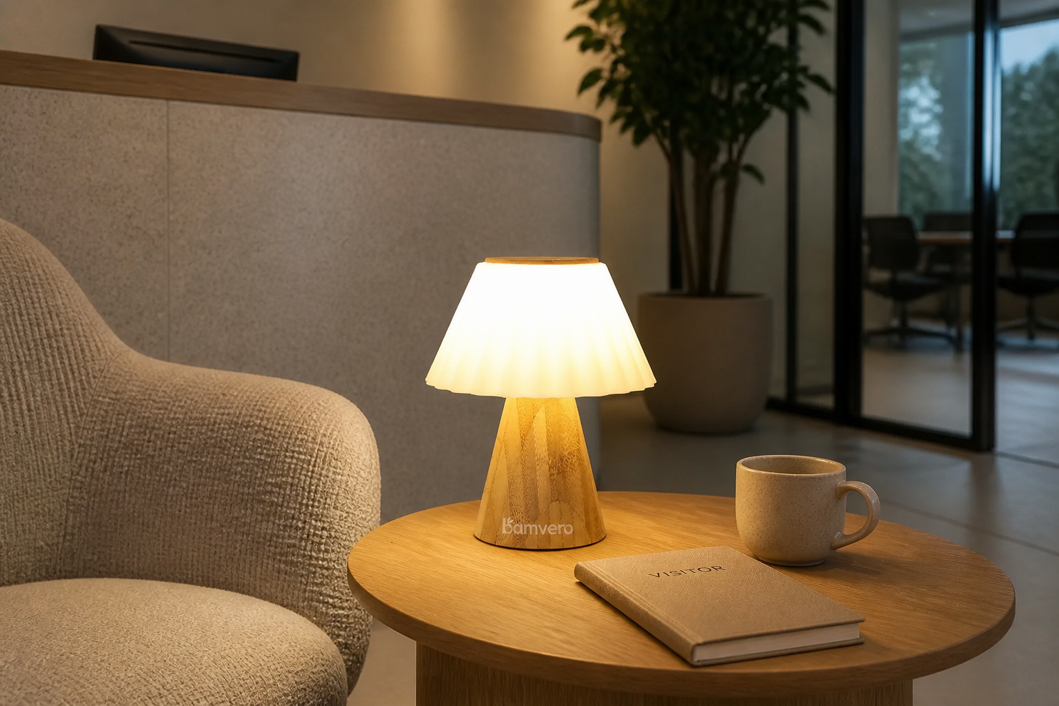 T2631 bamboo pleated table lamp glowing on a side table in a contemporary office reception lounge